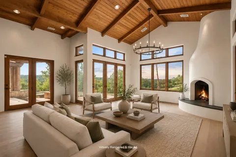 a view of a big room with windows and chandelier