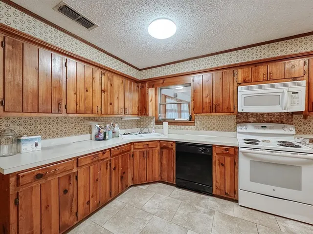 a kitchen with a sink stove and cabinets