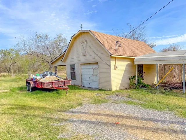 an aerial view of a house with a yard