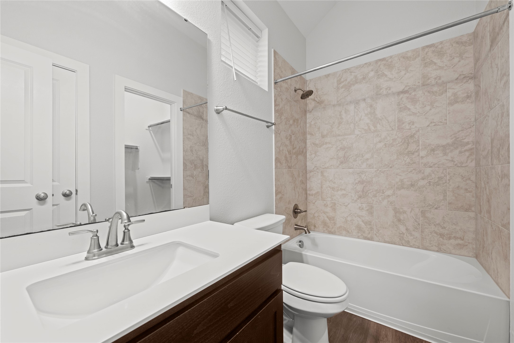 60 Rancho Trail Georgetown, TX 78628 - Photo 22 of 36 Tiled tub surround meets modern cabinetry in this well-appointed bathroom.