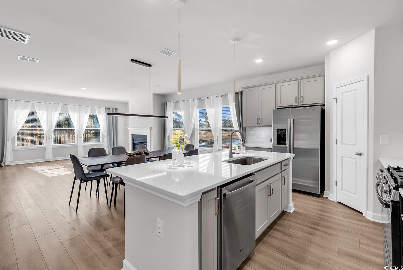 3104 Palma Way Myrtle Beach, SC 29579 - Photo 40 of 40 Kitchen with open floor plan, stainless steel appliances, a center island with sink, light wood-style floors, and pendant lighting
