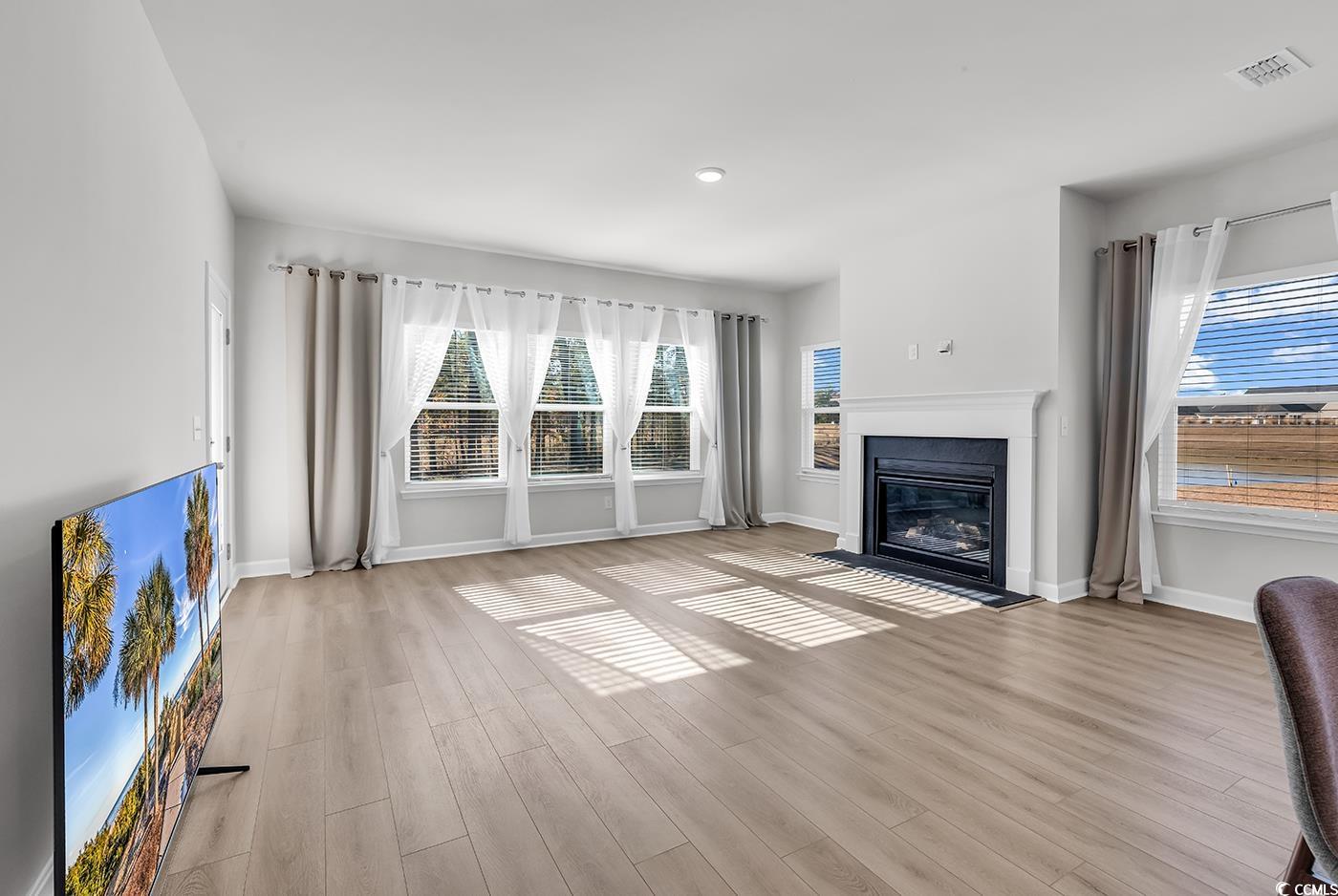 3104 Palma Way Myrtle Beach, SC 29579 - Photo 18 of 40 Unfurnished living room featuring a fireplace with flush hearth and light wood finished floors