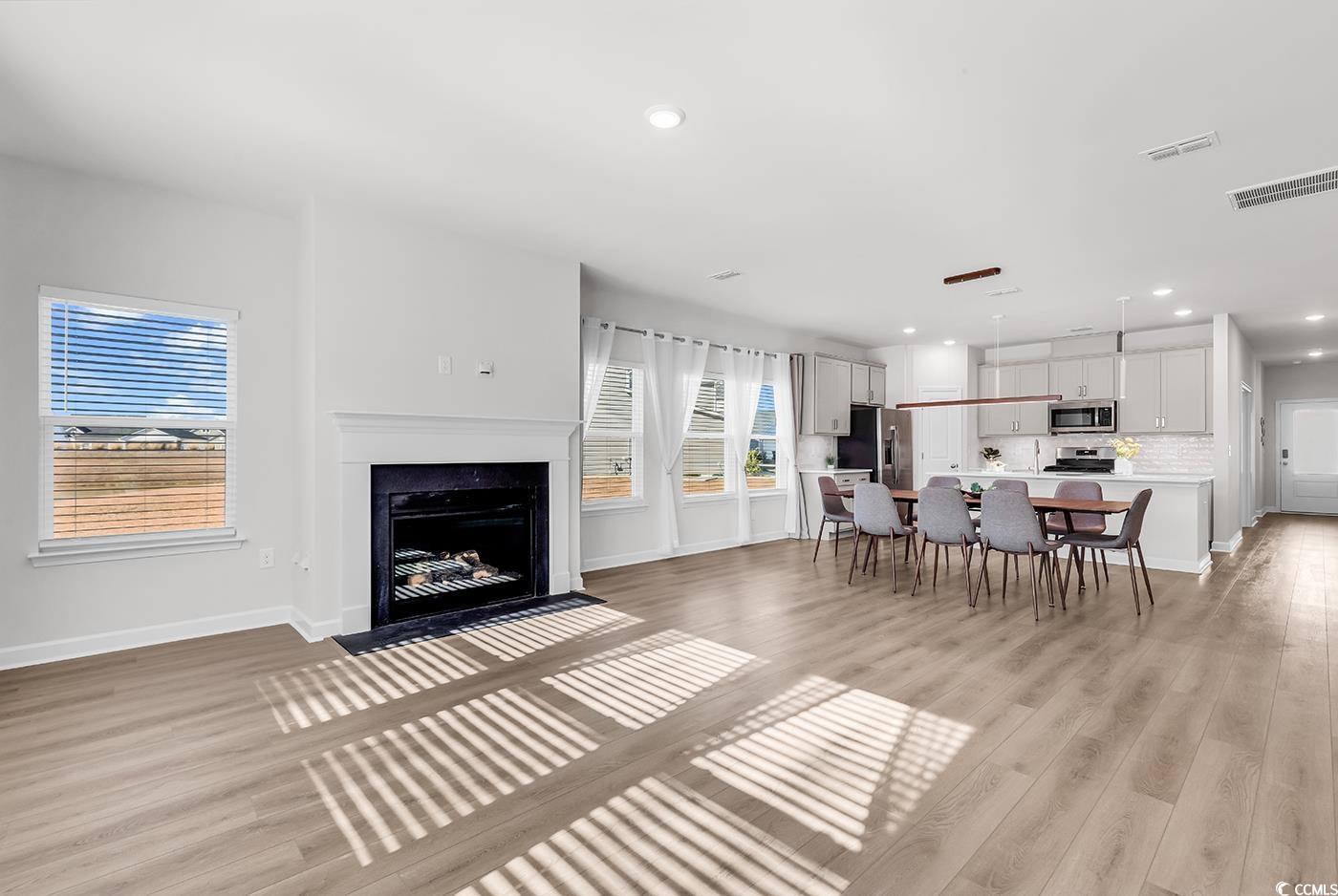 3104 Palma Way Myrtle Beach, SC 29579 - Photo 20 of 40 Living area featuring a fireplace with flush hearth, recessed lighting, and light wood-style floors