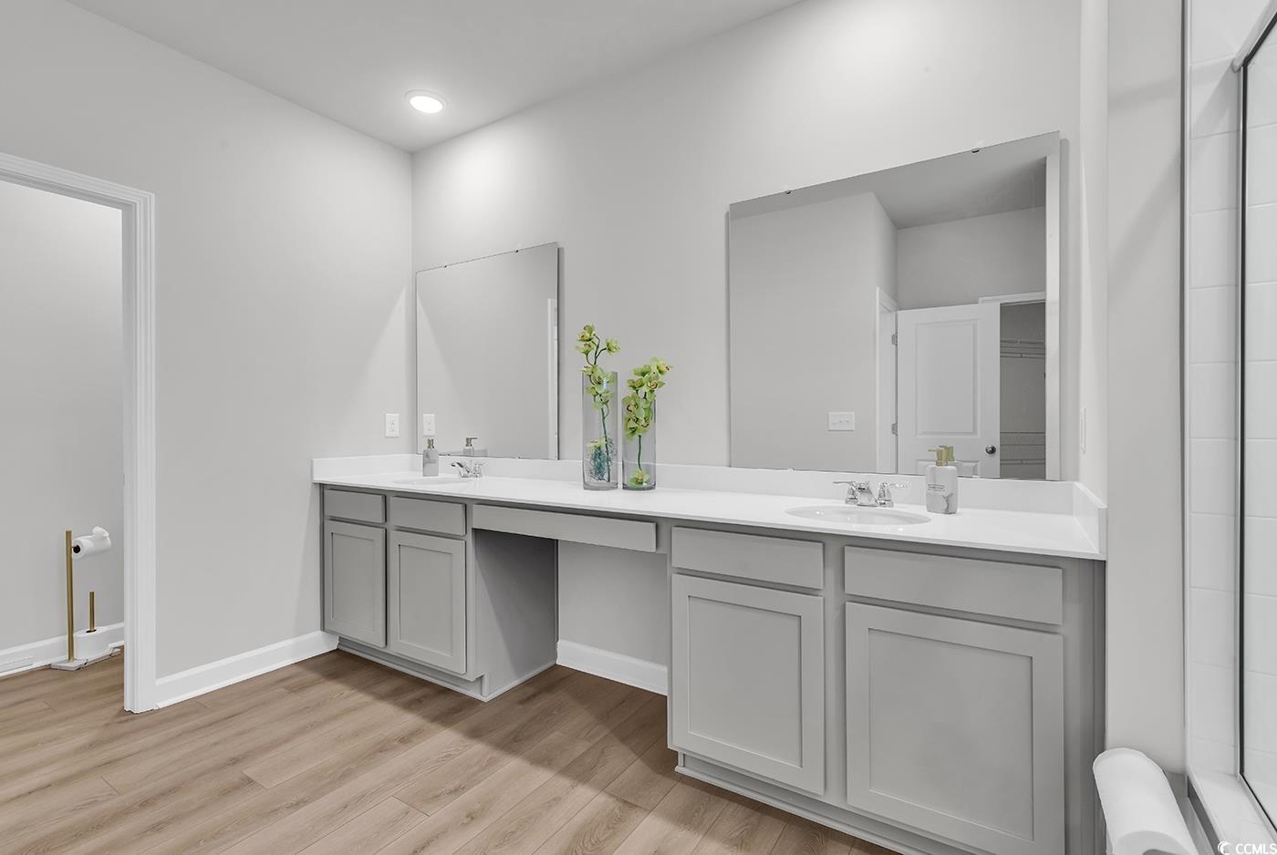 3104 Palma Way Myrtle Beach, SC 29579 - Photo 27 of 40 Bathroom featuring double vanity, light wood-style floors, and a tile shower