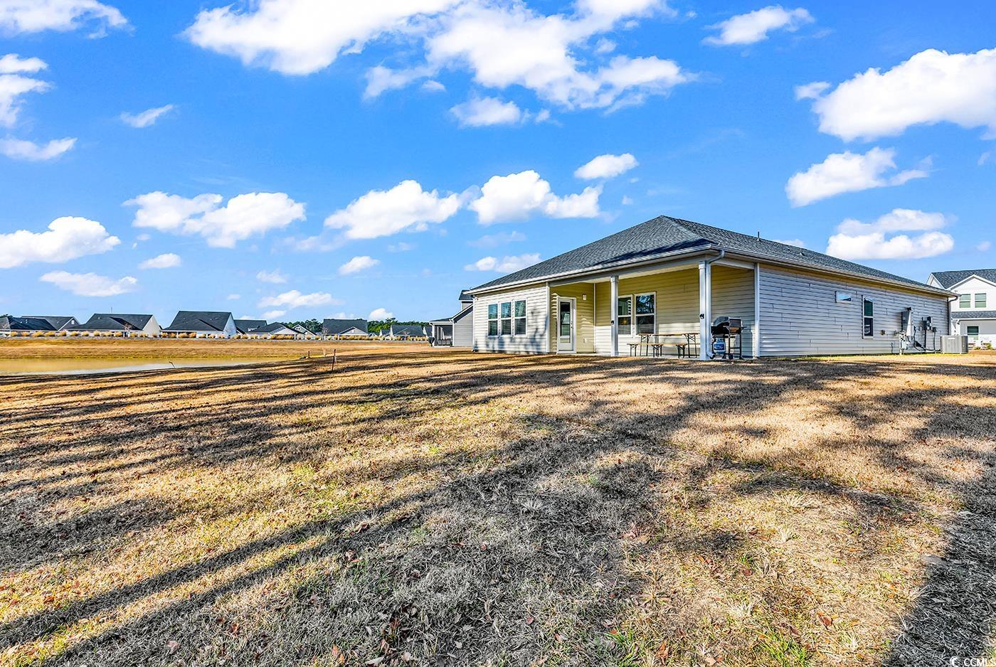 3104 Palma Way Myrtle Beach, SC 29579 - Photo 35 of 40 Rear view of house with a patio area and a lawn