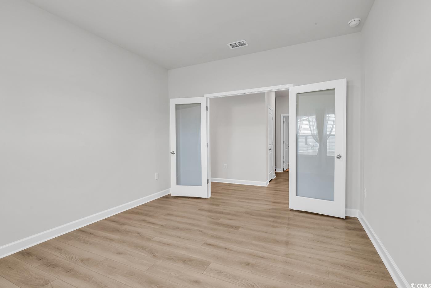 3104 Palma Way Myrtle Beach, SC 29579 - Photo 8 of 40 Unfurnished bedroom with french doors and light wood-type flooring