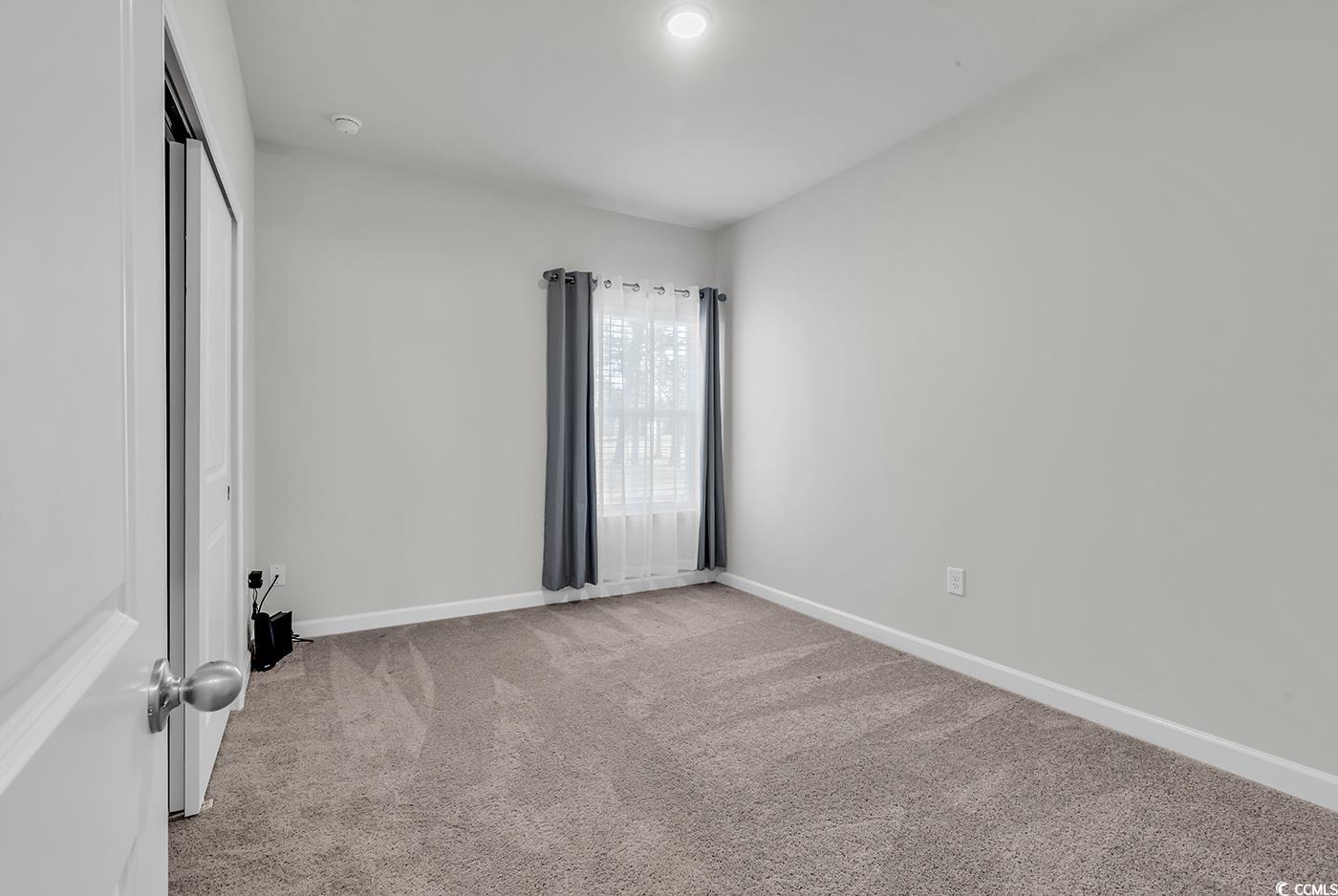 3104 Palma Way Myrtle Beach, SC 29579 - Photo 9 of 40 Empty room featuring light carpet and baseboards