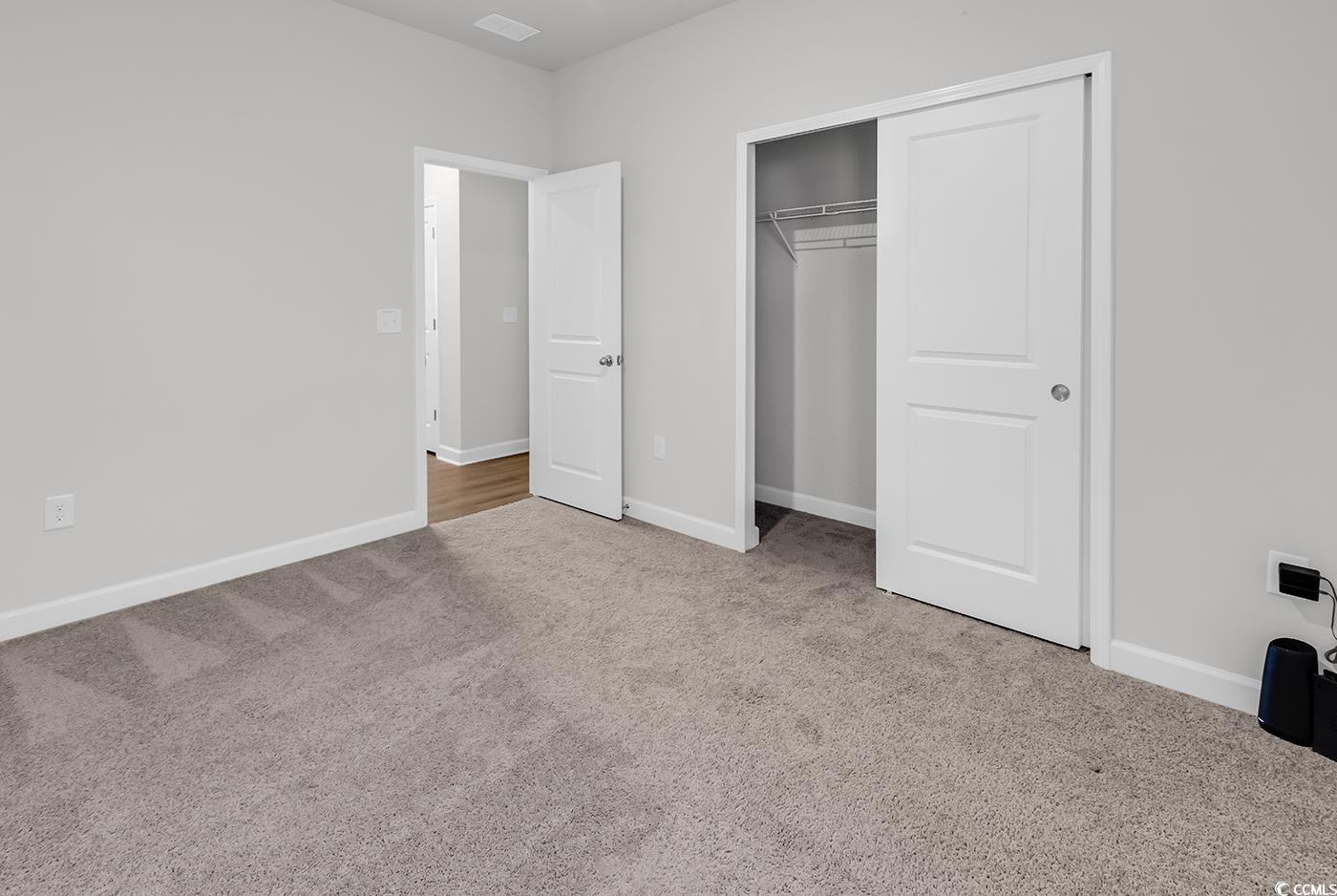 3104 Palma Way Myrtle Beach, SC 29579 - Photo 10 of 40 Unfurnished bedroom featuring light colored carpet and a closet