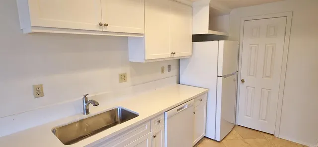 a utility room with cabinets washer and dryer