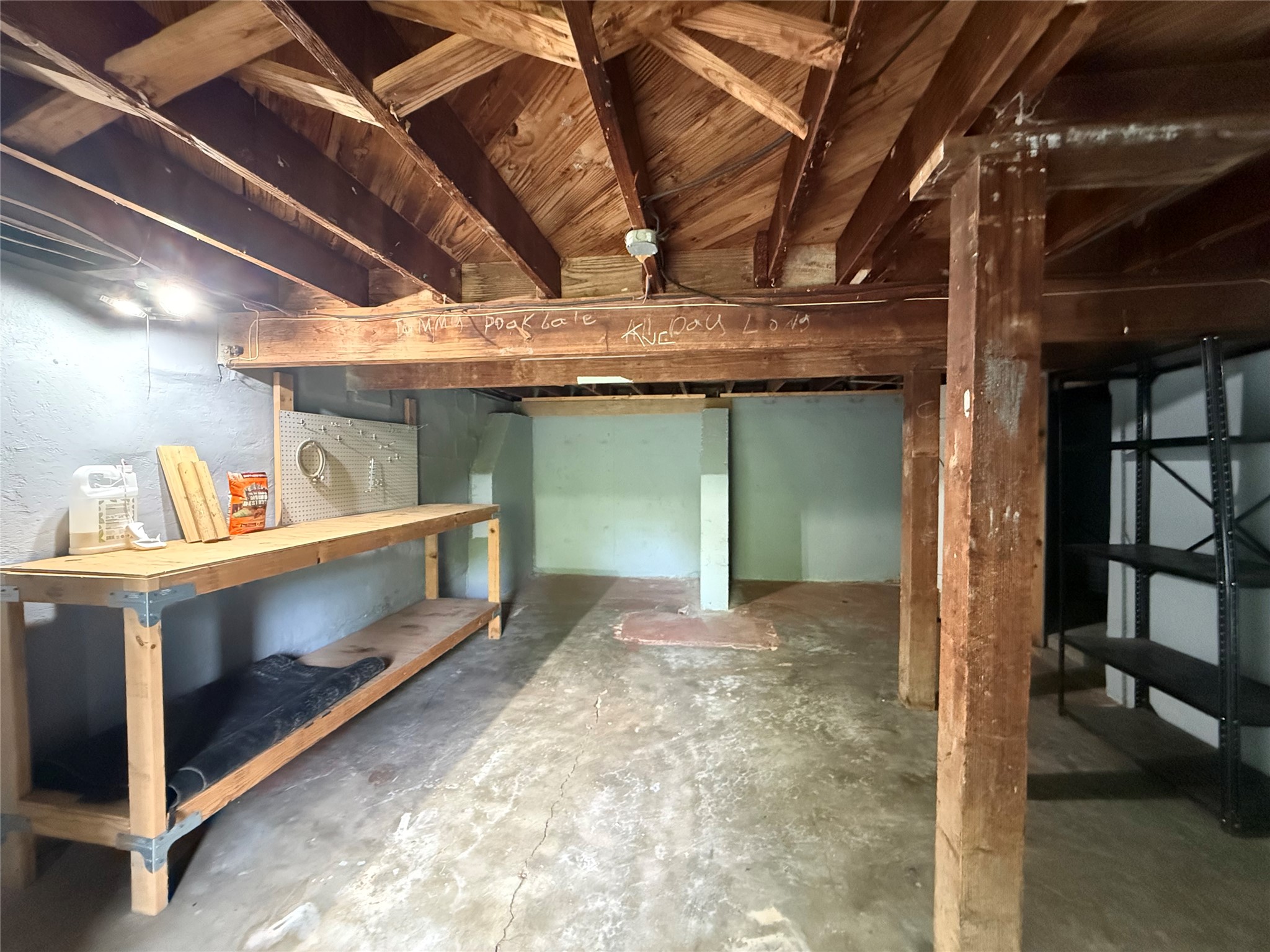 3305 Merrie Lynn Avenue Austin, TX 78722 - Photo 20 of 22 A utilitarian unfinished basement offers ample space for storage and potential for future development.