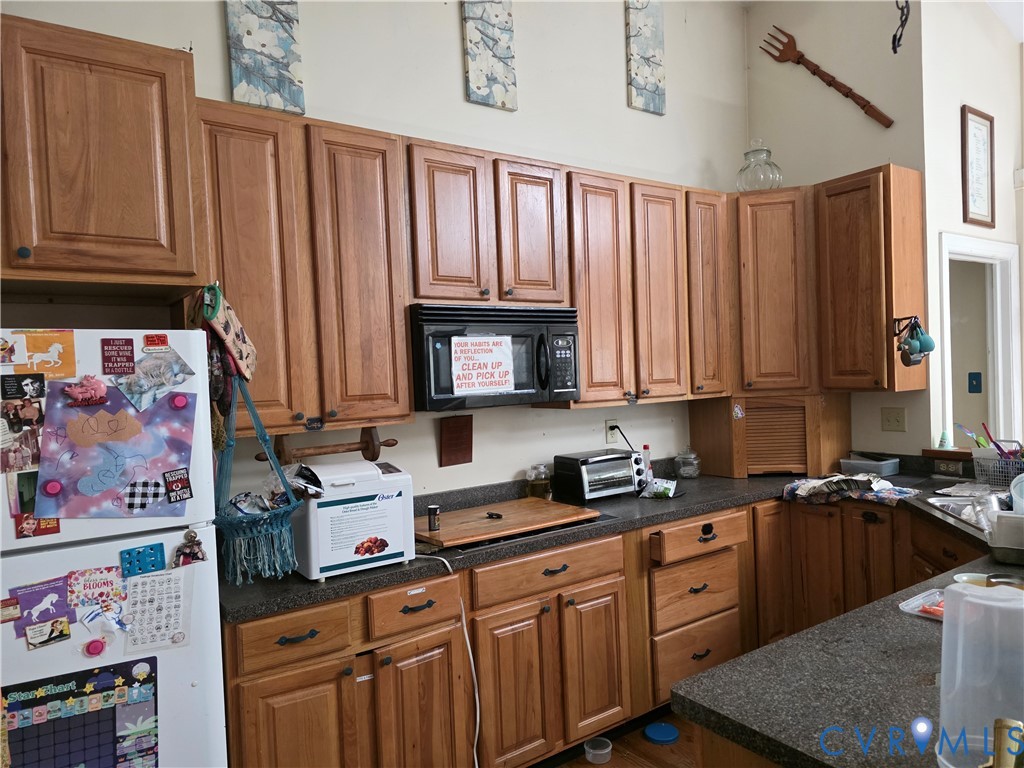 3161 Dorrell Road Aylett, VA 23009 - Photo 8 of 41 a kitchen with stainless steel appliances granite countertop a refrigerator sink and cabinets