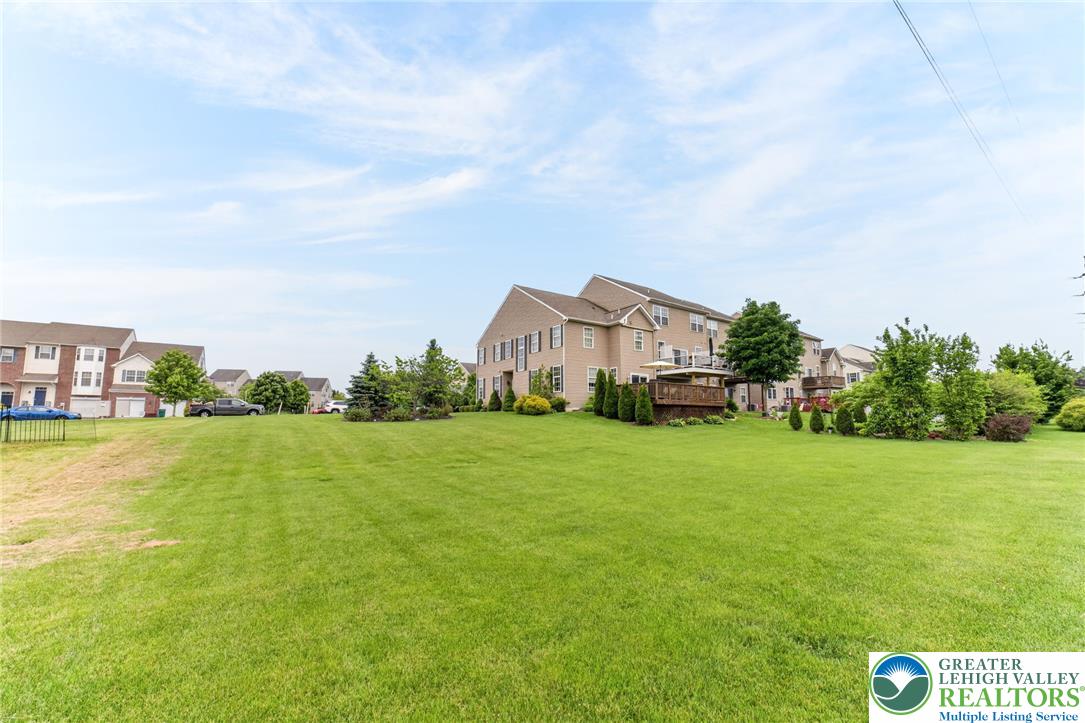 5440 Spring Ridge Drive West Macungie, PA 18062 - Photo 36 of 40 A tranquil rear lawn offers ample green space behind this welcoming residential dwelling.