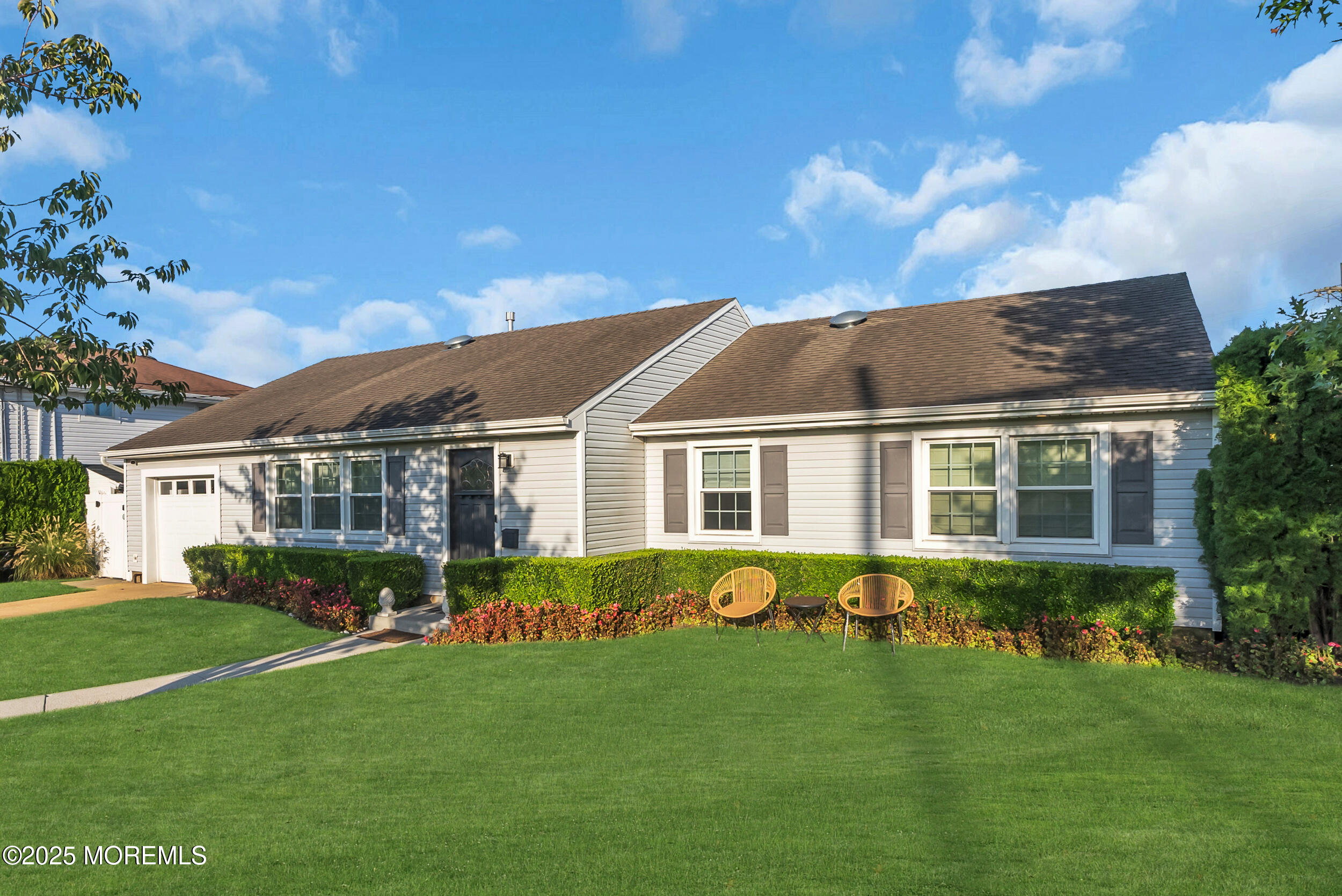 a front view of house with yard and green space