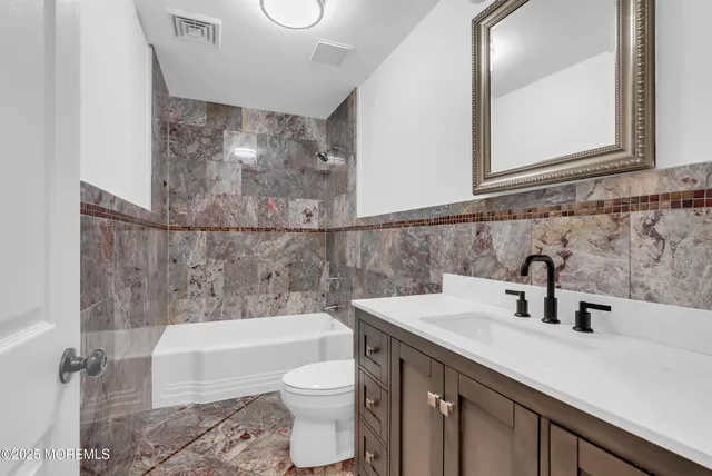 a bathroom with a sink a toilet and bathtub