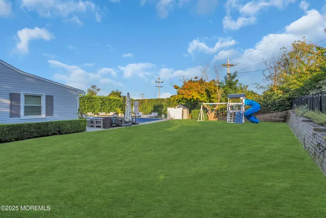 a view of a patio with couches and a table and chairs with garden view