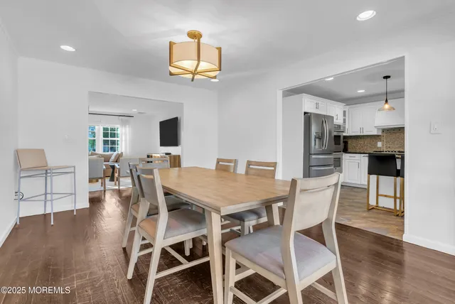 a dining room with furniture and wooden floor
