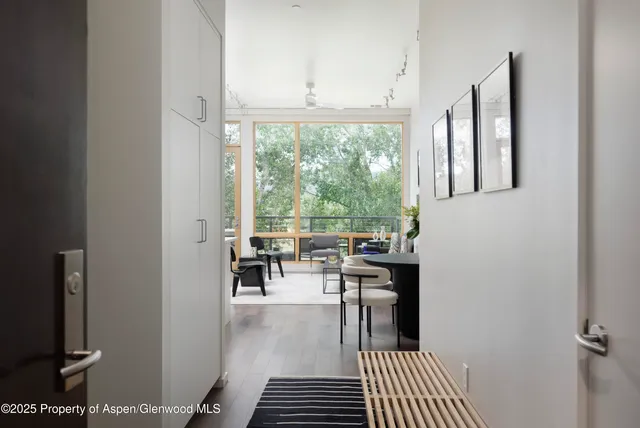 a dining room with wooden floor and a rug