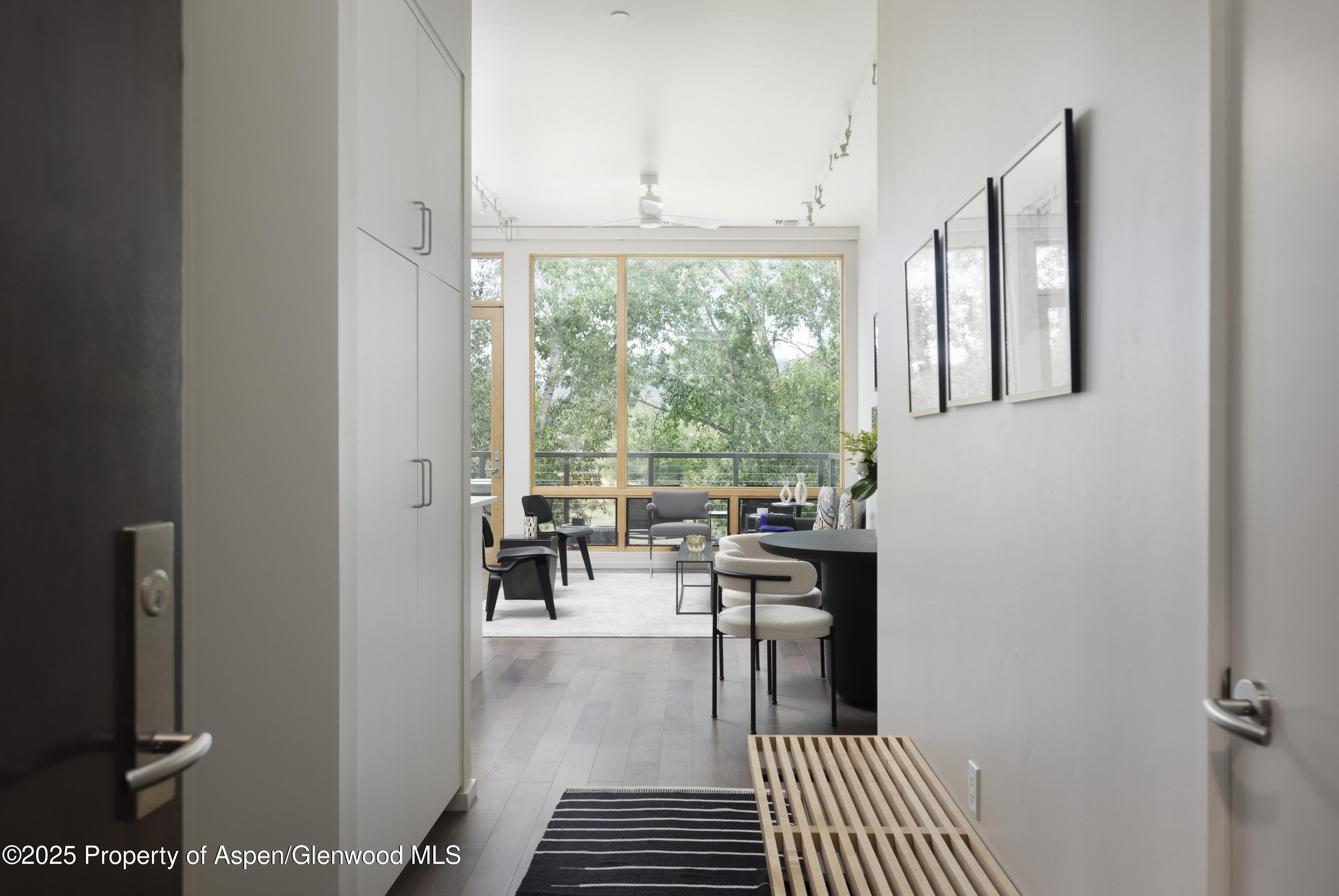 104 Evans Road, Unit 207 Basalt, CO 81621 - Photo 2 of 10 a dining room with wooden floor and a rug