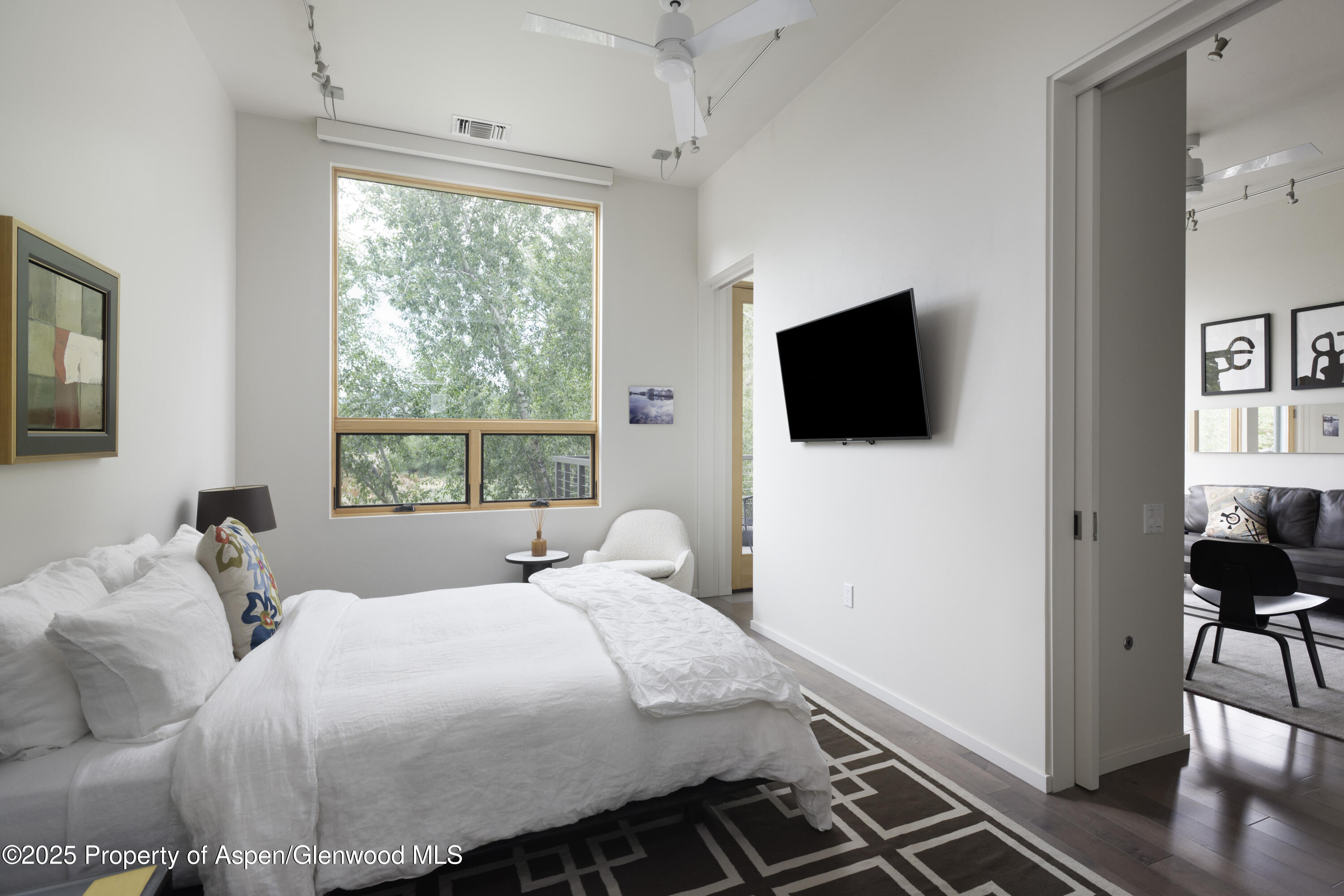 104 Evans Road, Unit 207 Basalt, CO 81621 - Photo 6 of 10 a bedroom with a bed and a flat tv screen on the dresser