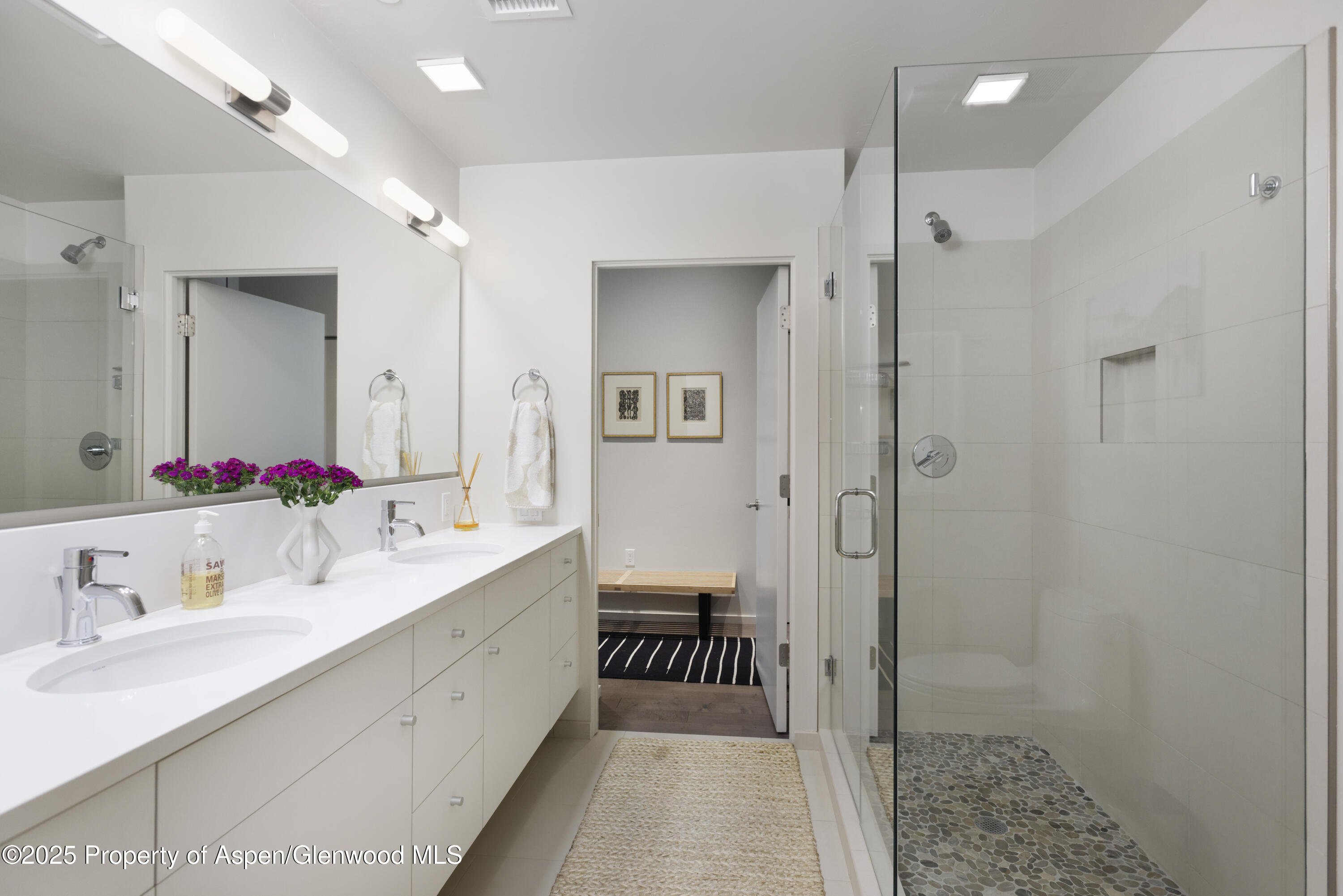 104 Evans Road, Unit 207 Basalt, CO 81621 - Photo 7 of 10 a bathroom with a double vanity sink a mirror and a shower