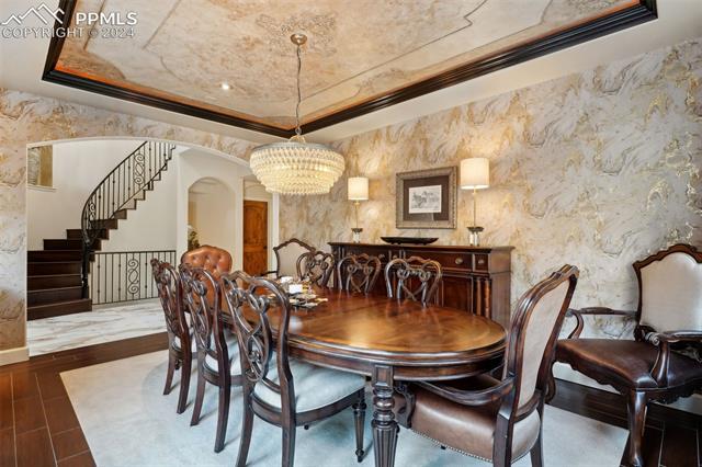 2204 Rocking Horse Court Colorado Springs, CO 80921 - Photo 11 of 50 Dining area featuring an inviting chandelier and a raised ceiling