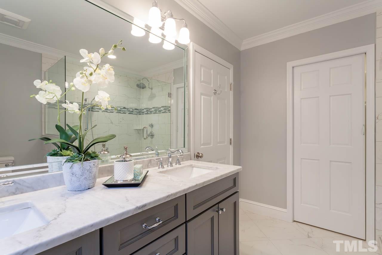 2333 Mt Vernon Church Road Raleigh, NC 27614 - Photo 13 of 24 a bathroom with a sink a potted plant and a mirror
