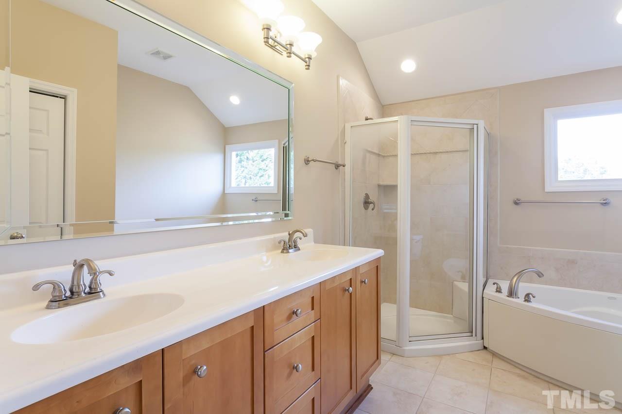 2333 Mt Vernon Church Road Raleigh, NC 27614 - Photo 15 of 24 a bathroom with a sink double vanity granite tub shower and a mirror