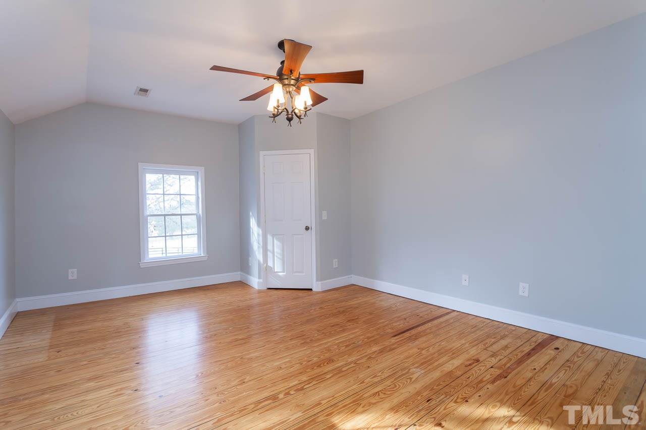 2333 Mt Vernon Church Road Raleigh, NC 27614 - Photo 17 of 24 a view of empty room with wooden floor and fan