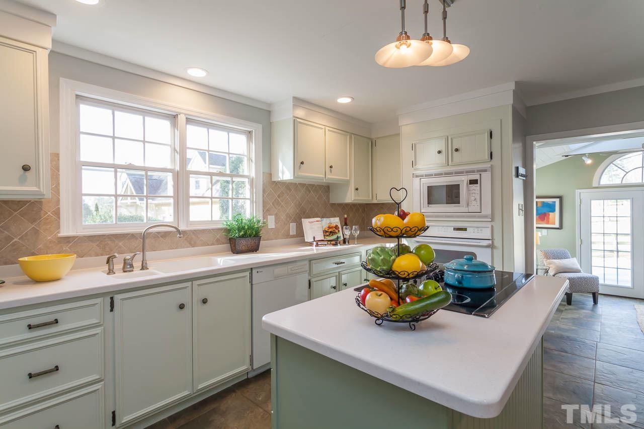 2333 Mt Vernon Church Road Raleigh, NC 27614 - Photo 7 of 24 a kitchen with stainless steel appliances granite countertop a sink a stove and wooden floors