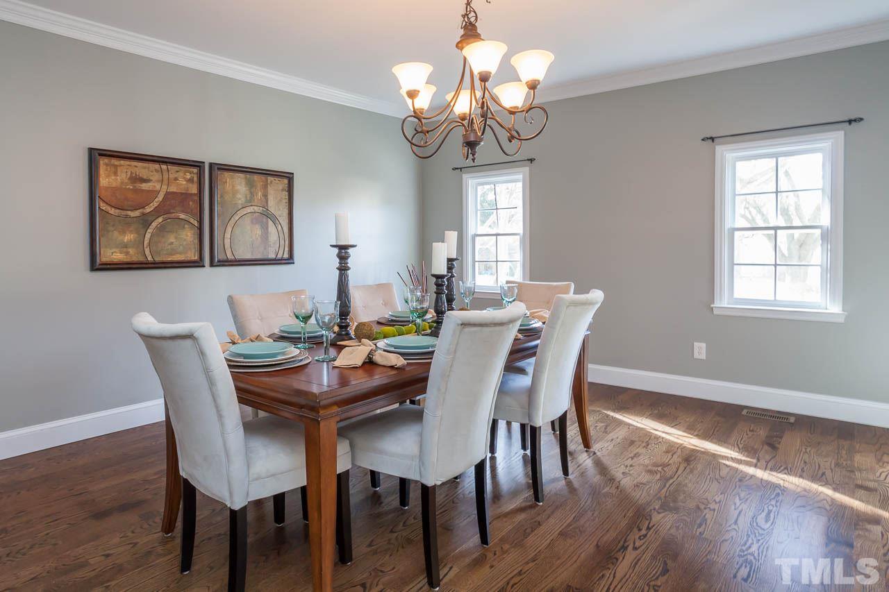 2333 Mt Vernon Church Road Raleigh, NC 27614 - Photo 8 of 24 a view of a dining room with furniture wooden floor and a chandelier