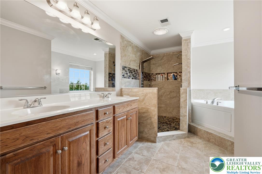 245 East Dell Road Bath, PA 18014 - Photo 39 of 99 Dual vanities and a tiled walk-in shower provide a luxurious and functional space.