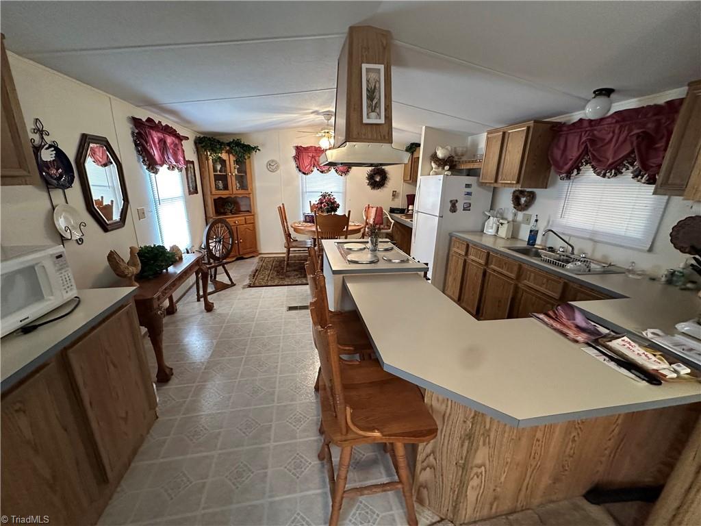 3661 Darnell Woodie Road Laurel Springs, NC 28644 - Photo 20 of 29 View of kitchen/dining area with additional storage and microwave