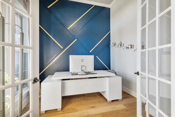 a kitchen with a refrigerator and wooden floor