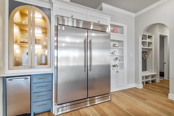 a kitchen with stainless steel appliances granite countertop a sink a stove and a refrigerator