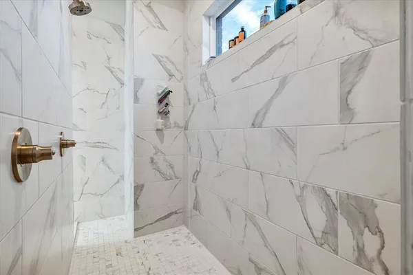 a spacious bathroom with a double vanity sink a mirror and a bathtub