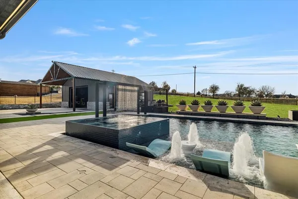 a view of swimming pool with outdoor seating and yard