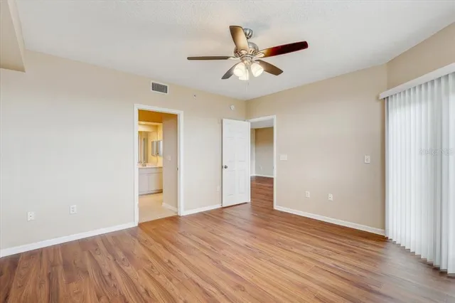 a view of empty room with wooden floor