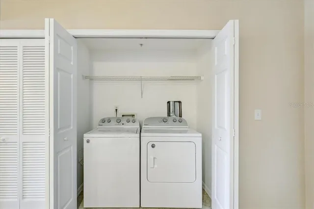 a view of storage and utility room with washer and dryer