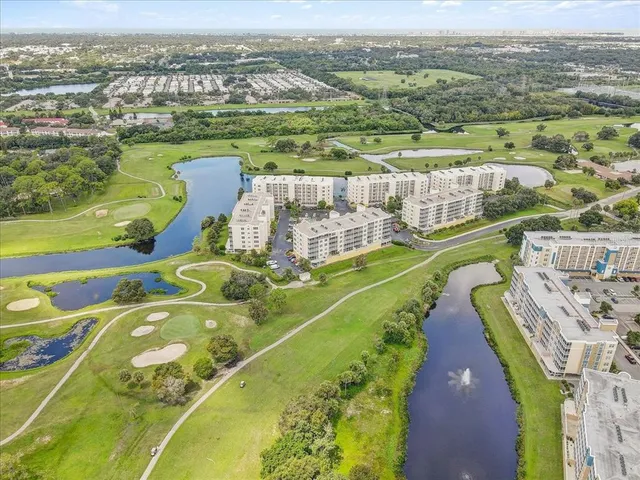 an aerial view of a house with a big yard