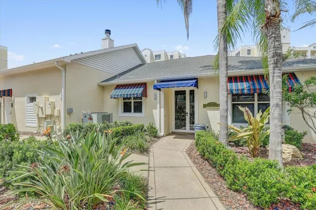 front view of a house with potted plants
