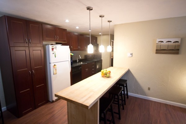 188 Swanson Road, Unit 326 Boxborough, MA 01719 - Photo 4 of 14 a kitchen with refrigerator and wooden floor