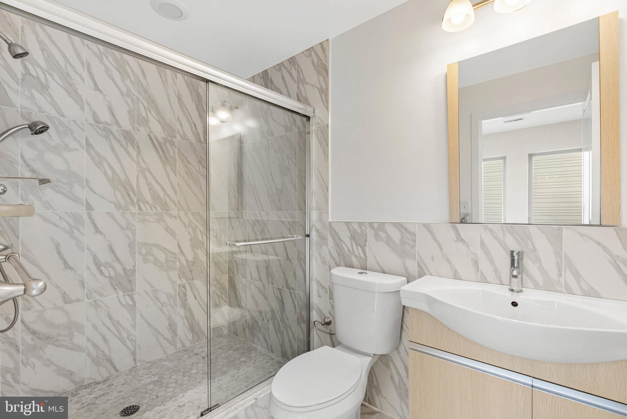 1238 North 6th Street, Unit B Philadelphia, PA 19122 - Photo 14 of 21 a bathroom with a sink a toilet and shower