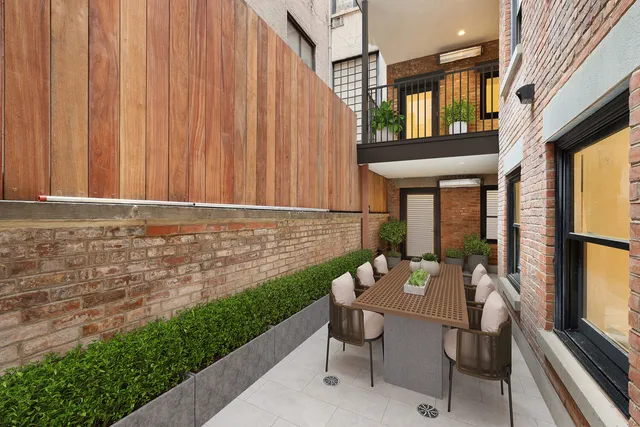 a view of a patio with table and chairs and potted plants