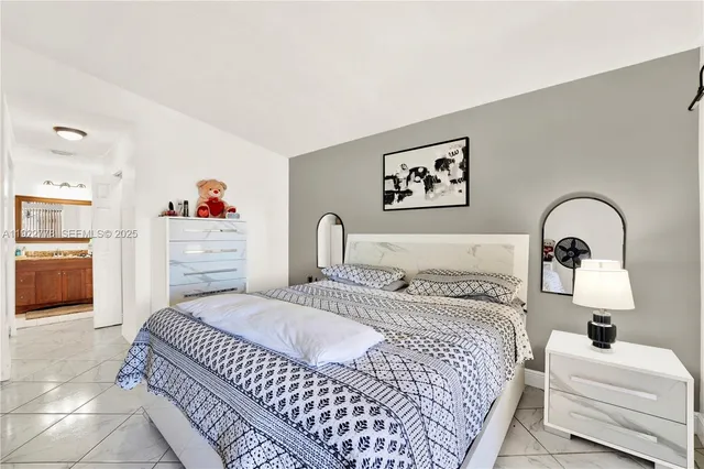 a bedroom with a bed and a view of kitchen