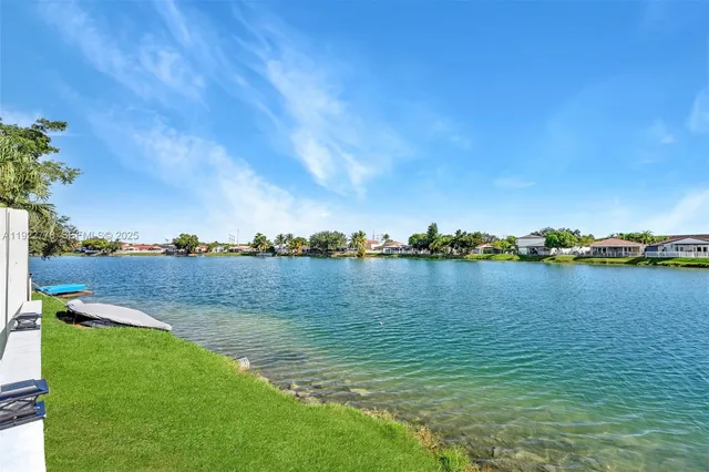 a view of a lake with houses in the back