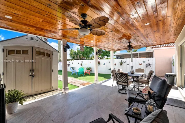 a view of a patio with table and chairs and potted plants
