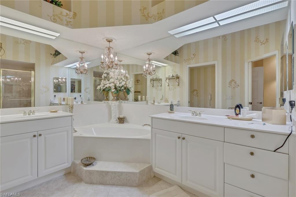 10801 Crooked River Road, Unit 203 Estero, FL 34135 - Photo 22 of 27 a bathroom with a sink double vanity and a mirror