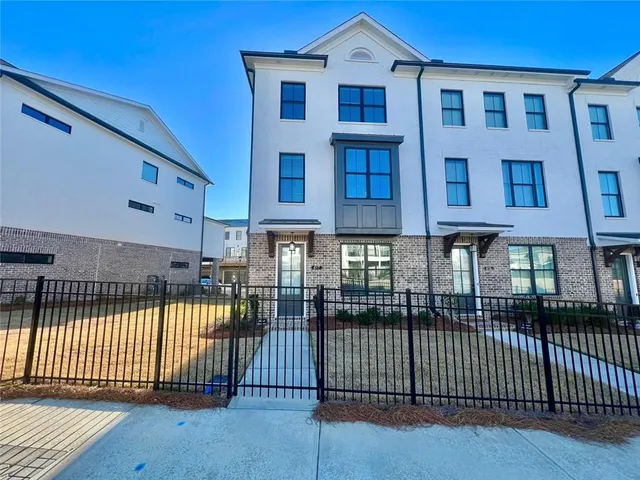 a view of a brick house with many windows