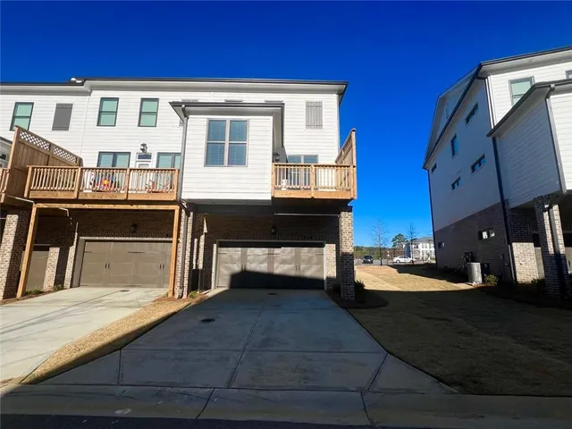 a view of a house with wooden deck