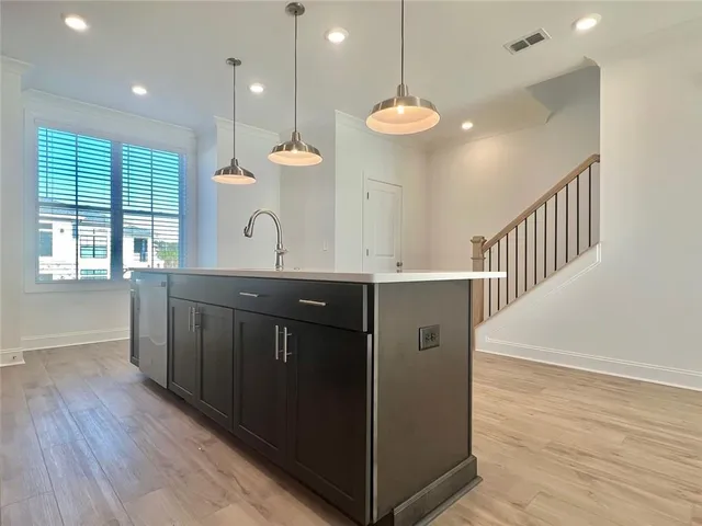 a kitchen with a counter space a sink and chandelier